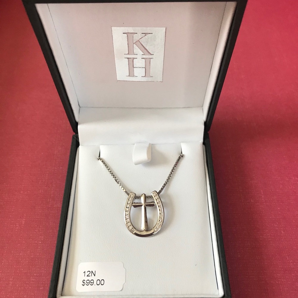 Silver horseshoe necklace with a cross